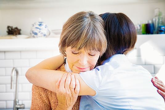 Two women hugging and comforting each other